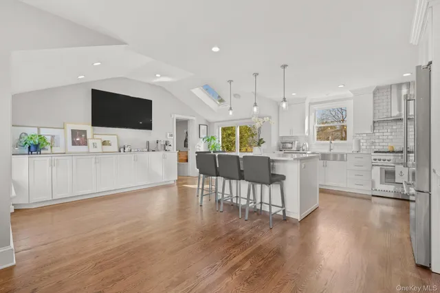 a living room with furniture wooden floor and a flat screen tv