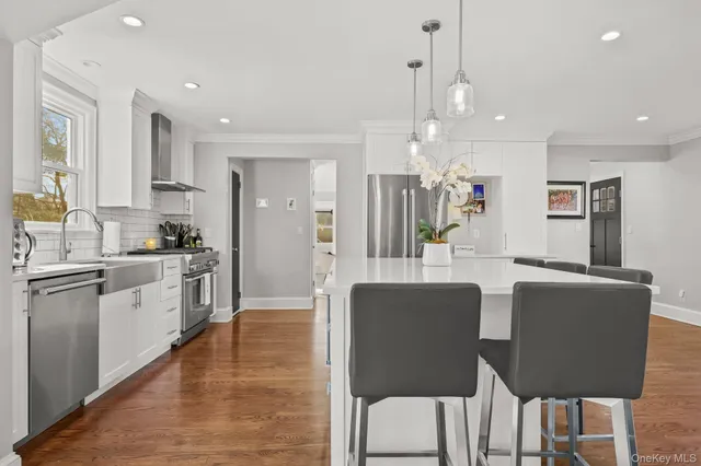 a large kitchen with cabinets table and chairs