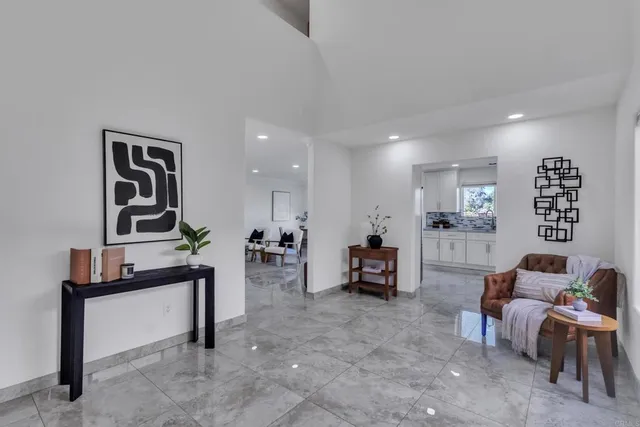 a kitchen with granite countertop white cabinets white stainless steel appliances with a sink and dishwasher