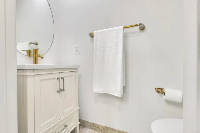 a white toilet sitting next to a white wall