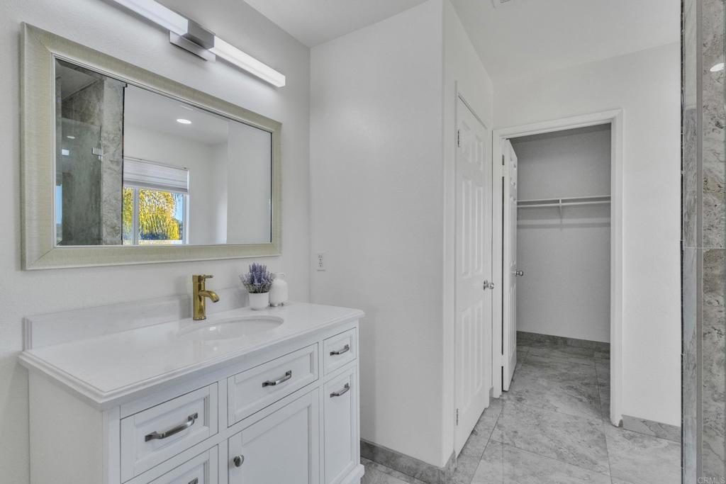13740 Gateway View Drive El Cajon, CA 92021 - Photo 19 of 45 a bathroom with a sink a light fixture a vanity and a mirror