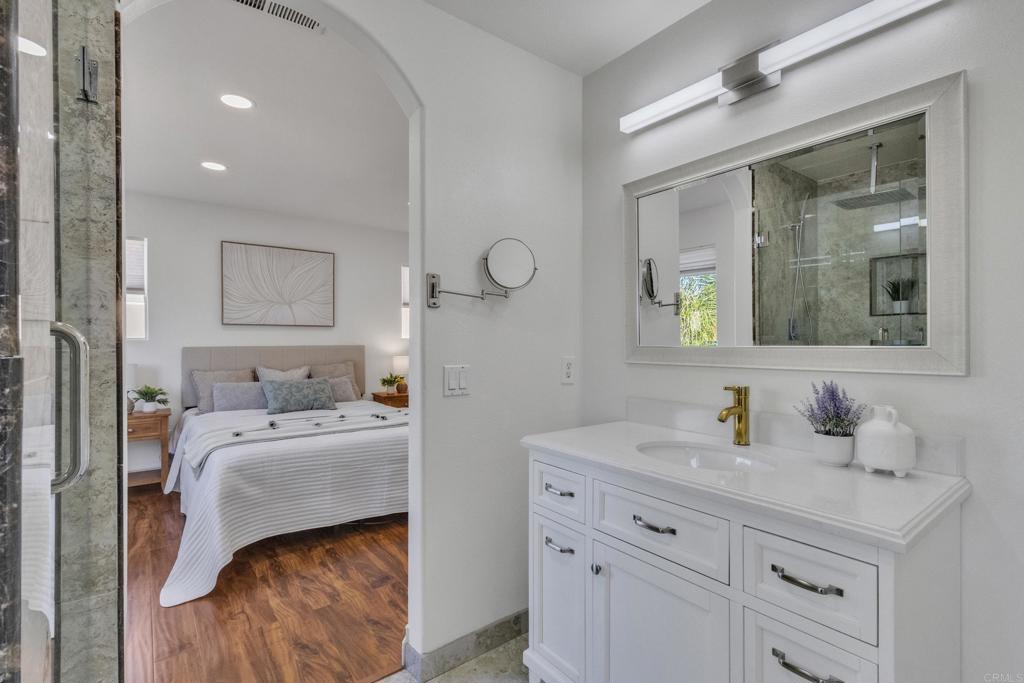 13740 Gateway View Drive El Cajon, CA 92021 - Photo 22 of 45 a en suite bathroom with a granite countertop sink and a mirror