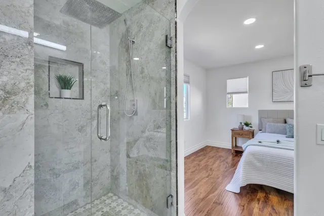 a bathroom with a granite countertop toilet and a sink