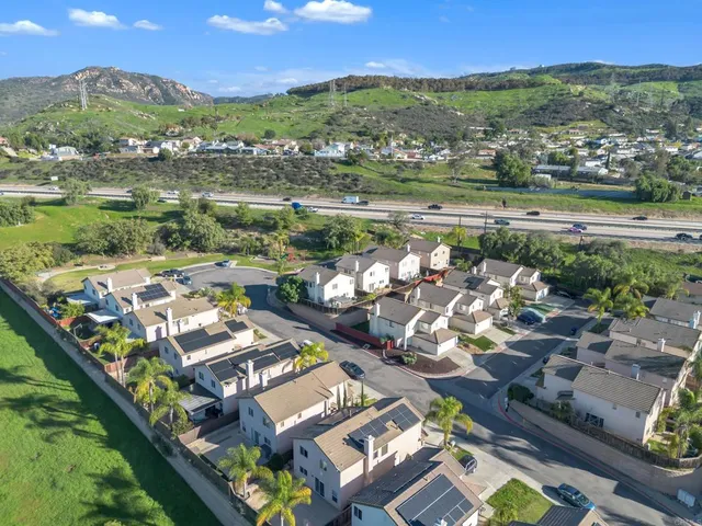 an aerial view of residential houses with outdoor space