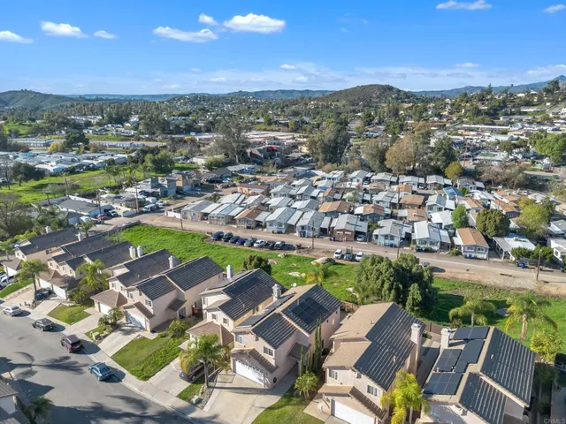 an aerial view of residential houses with outdoor space and street view