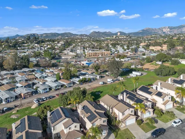 an aerial view of residential houses with outdoor space