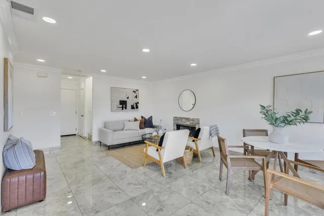 a dining room with furniture and wooden floor