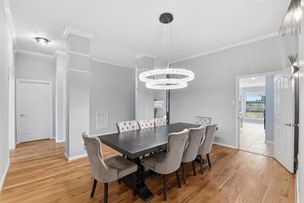 6534 Granbury Road Manvel, TX 77578 - Photo 13 of 49 a view of a dining room with furniture wooden floor and chandelier