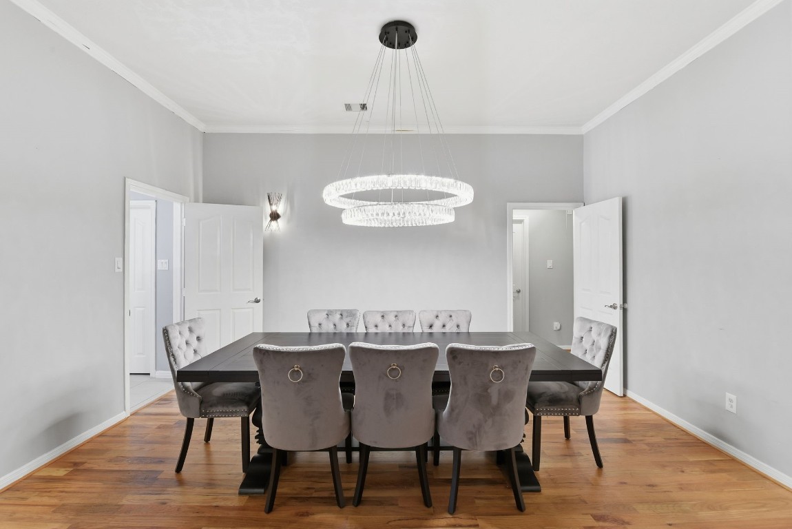 6534 Granbury Road Manvel, TX 77578 - Photo 15 of 49 a view of a dining room with furniture and wooden floor