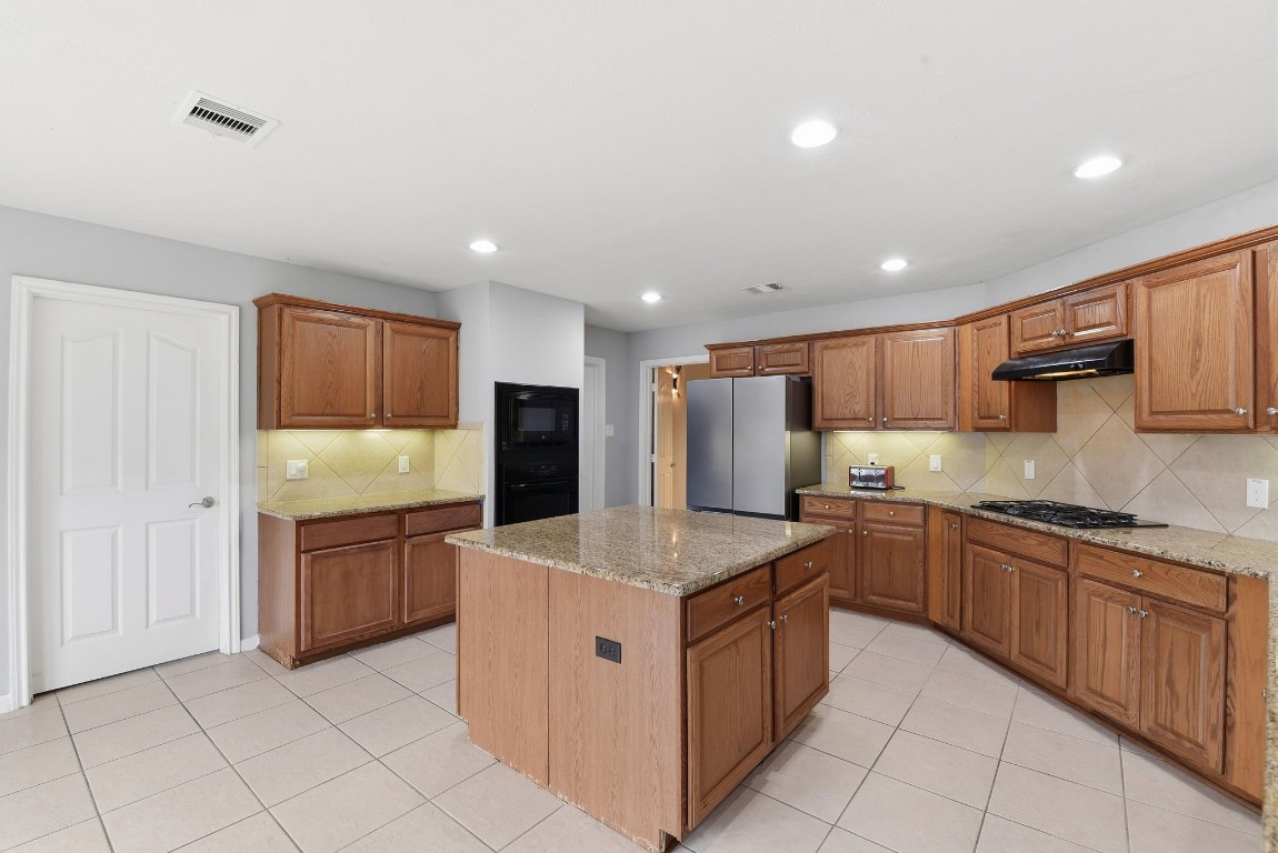 6534 Granbury Road Manvel, TX 77578 - Photo 24 of 49 a kitchen with stainless steel appliances granite countertop a sink counter space and cabinets