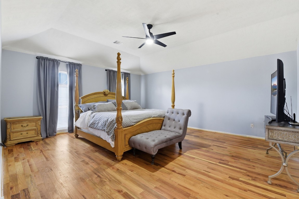 6534 Granbury Road Manvel, TX 77578 - Photo 28 of 49 a bedroom with a bed wooden floor and ceiling fan