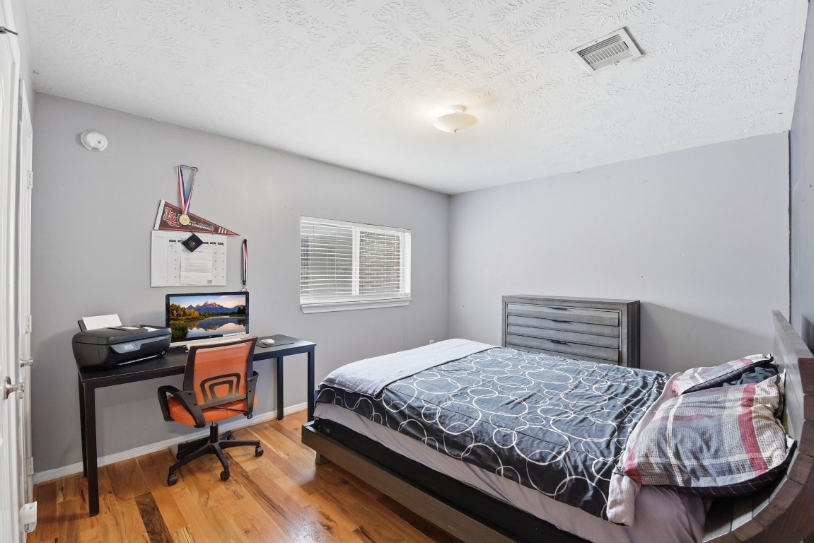 6534 Granbury Road Manvel, TX 77578 - Photo 38 of 49 a bedroom with a bed and a desk