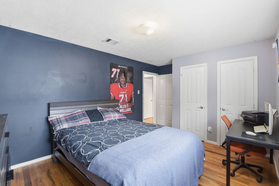 6534 Granbury Road Manvel, TX 77578 - Photo 39 of 49 a bedroom with a bed and a window