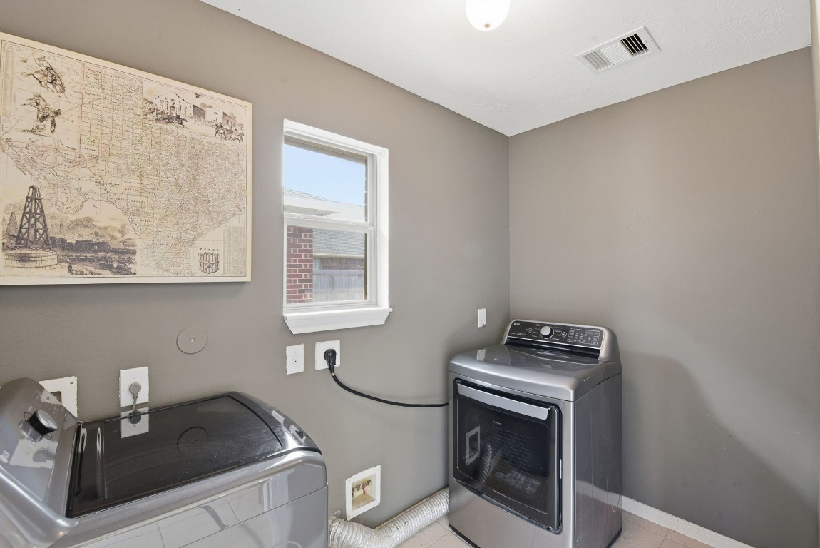 6534 Granbury Road Manvel, TX 77578 - Photo 40 of 49 a kitchen with granite countertop a stove a sink and a microwave