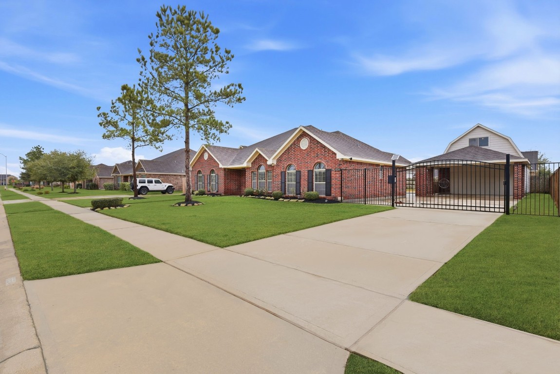 6534 Granbury Road Manvel, TX 77578 - Photo 7 of 49 a front view of a house with a yard and garage
