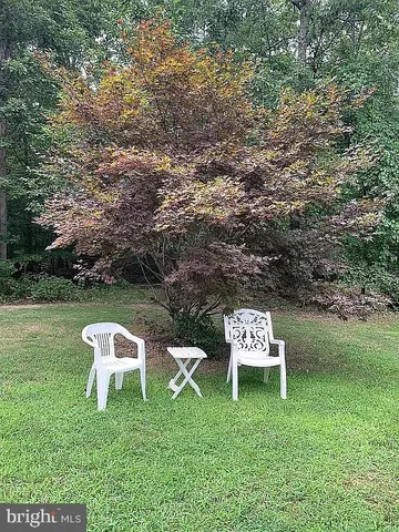 a backyard of a house with a yard and outdoor seating