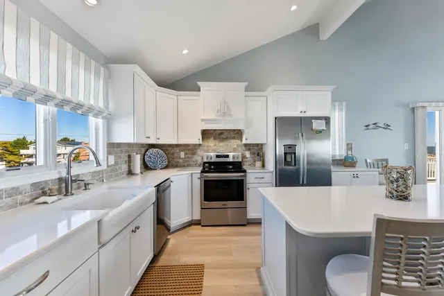 a kitchen with a sink stove and refrigerator