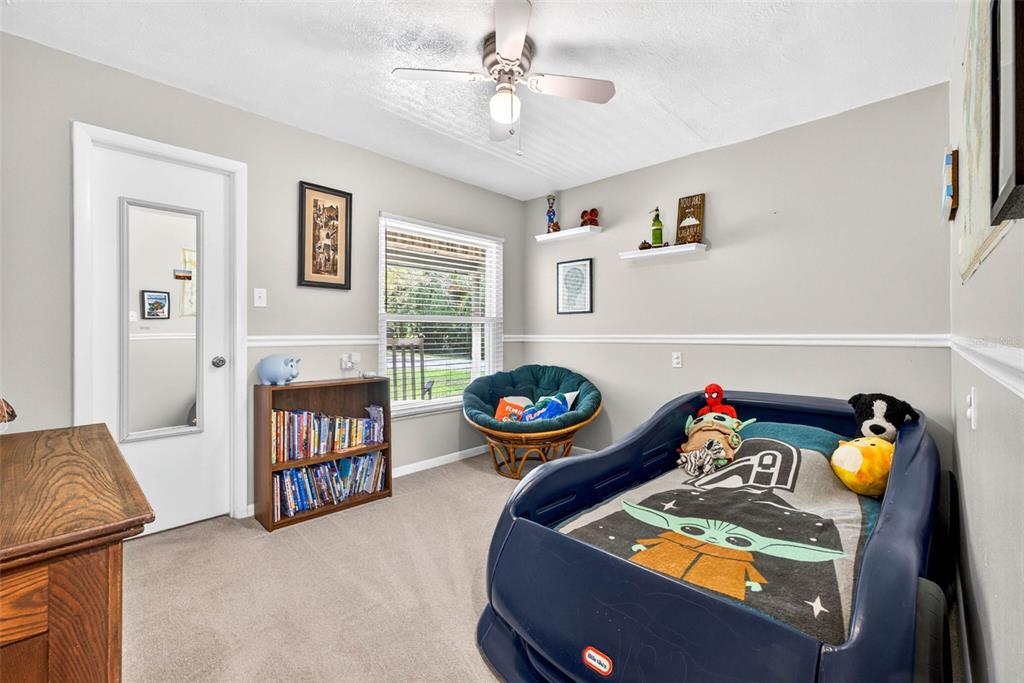16330 Hanna Road Lutz, FL 33549 - Photo 27 of 41 a living room with furniture a baby crib and a couch