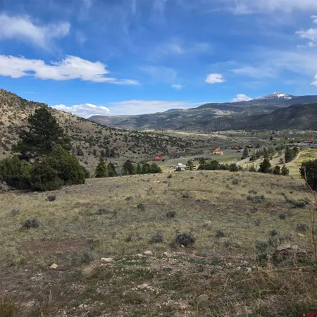a view of a dry yard with mountains in the background