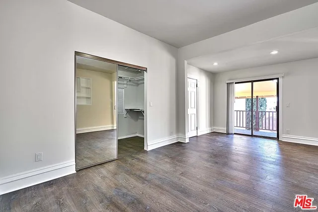 a view of a room with rack on the wall and a window