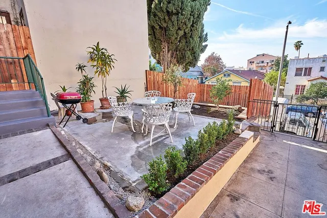 a view of a porch with wooden floor and fence
