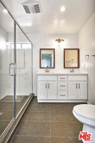 a bathroom with a toilet a sink and a shower