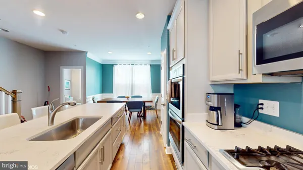 a kitchen with granite countertop a sink stove and cabinets