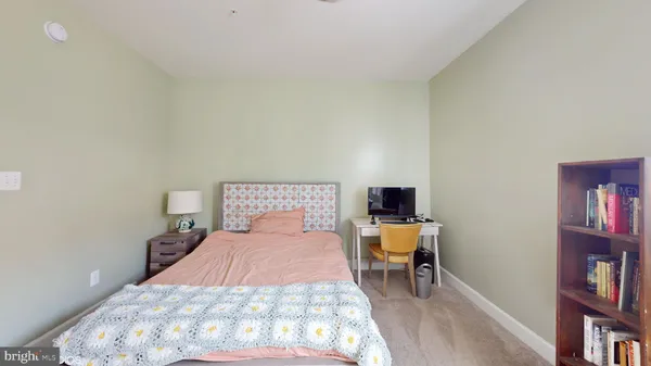 a bedroom with a bed and a bookshelf