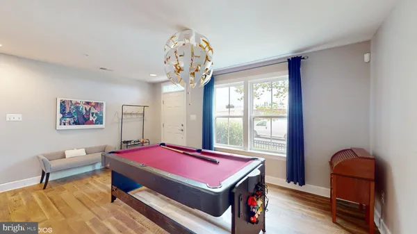 a room with pool table and windows