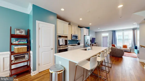 a open dining room with stainless steel appliances furniture a refrigerator and kitchen view