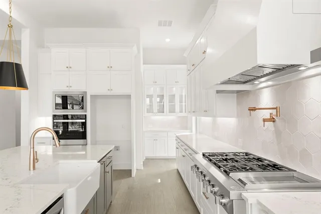 a view of white cabinets and sink