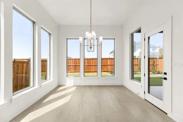 a view of a kitchen with refrigerator and cabinets