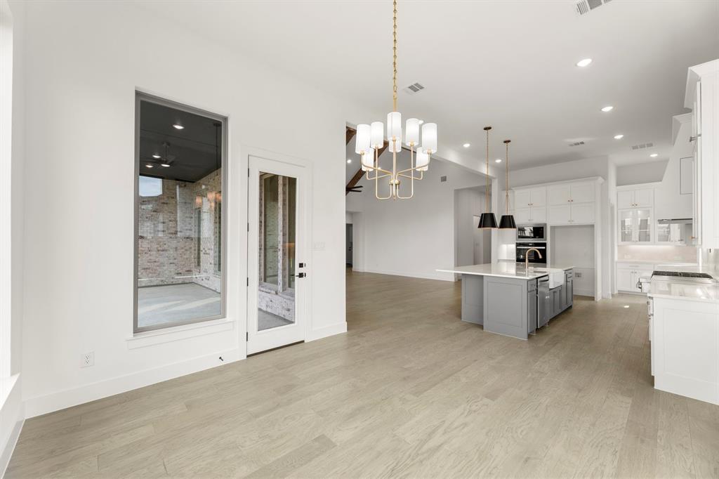 4416 Meander Way Prosper, TX 75078 - Photo 17 of 40 a view of a kitchen with refrigerator and cabinets
