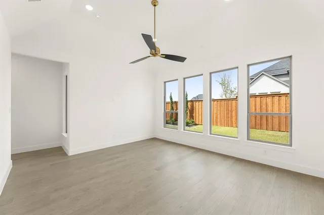 a view of a room with a hanging light and kitchen