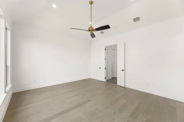 a spacious bathroom with a double vanity sink a large mirror and a bathtub