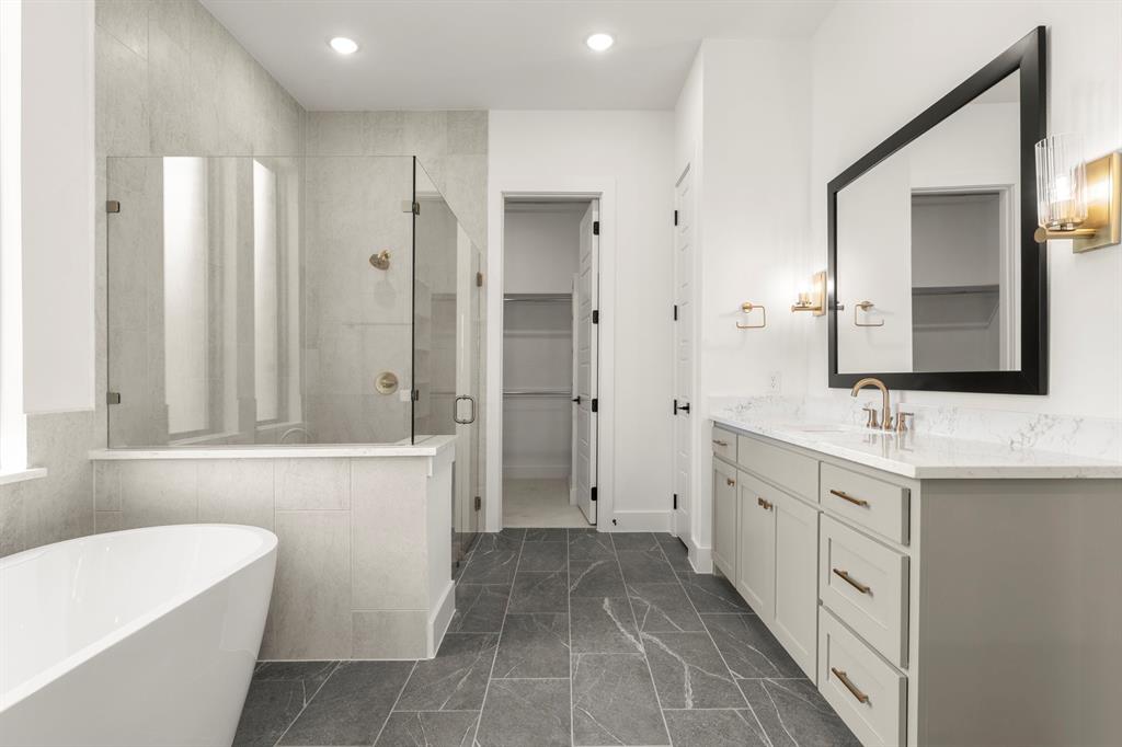 4416 Meander Way Prosper, TX 75078 - Photo 20 of 40 a spacious bathroom with a double vanity sink a large mirror and a bathtub