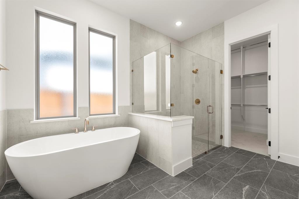 4416 Meander Way Prosper, TX 75078 - Photo 21 of 40 a white bath tub sitting in a bathroom and shower