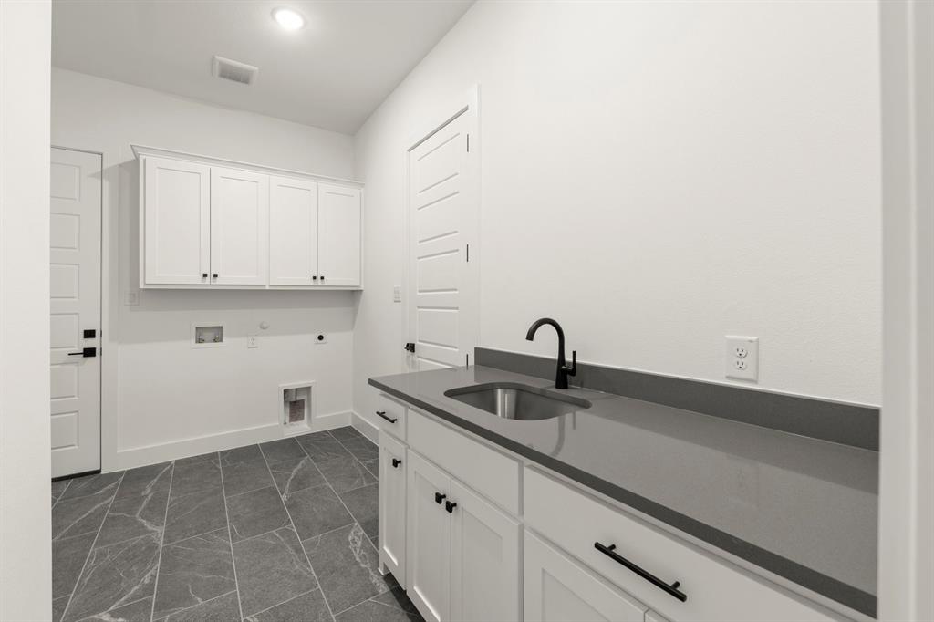 4416 Meander Way Prosper, TX 75078 - Photo 26 of 40 a kitchen with a sink and cabinets