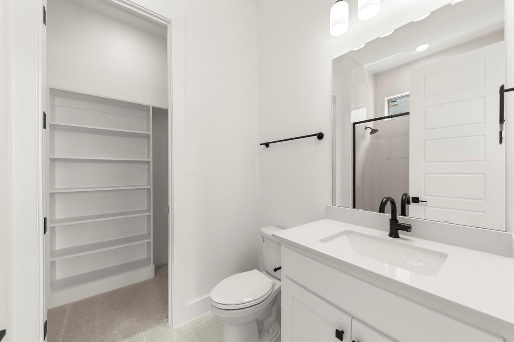 4416 Meander Way Prosper, TX 75078 - Photo 28 of 40 a bathroom with a sink a toilet and a mirror