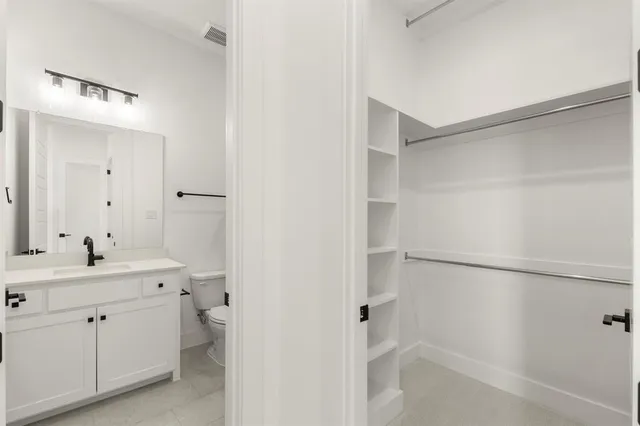 a bathroom with a sink toilet a mirror and shower