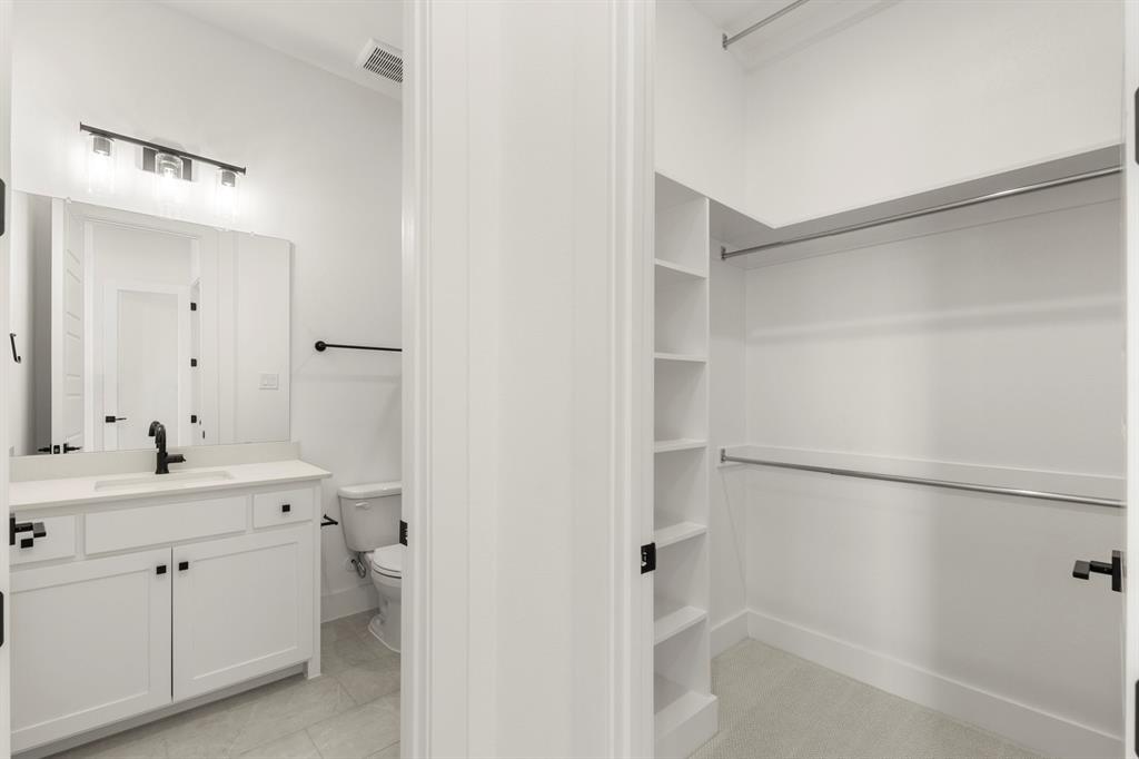 4416 Meander Way Prosper, TX 75078 - Photo 33 of 40 a spacious bathroom with a double vanity sink a mirror and a bathtub