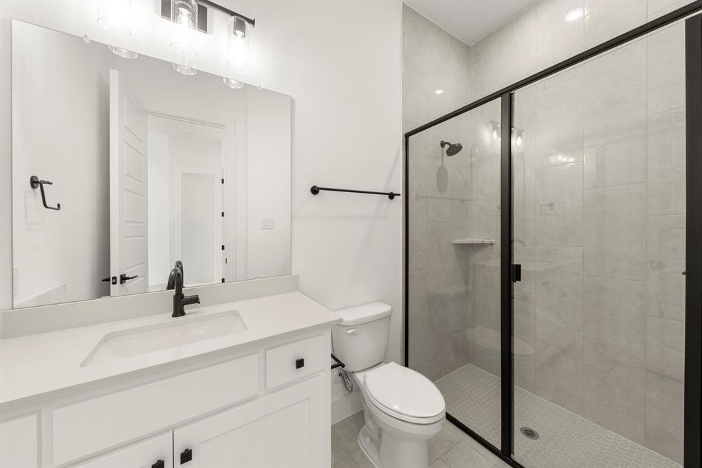 4416 Meander Way Prosper, TX 75078 - Photo 34 of 40 a bathroom with a sink toilet a mirror and shower