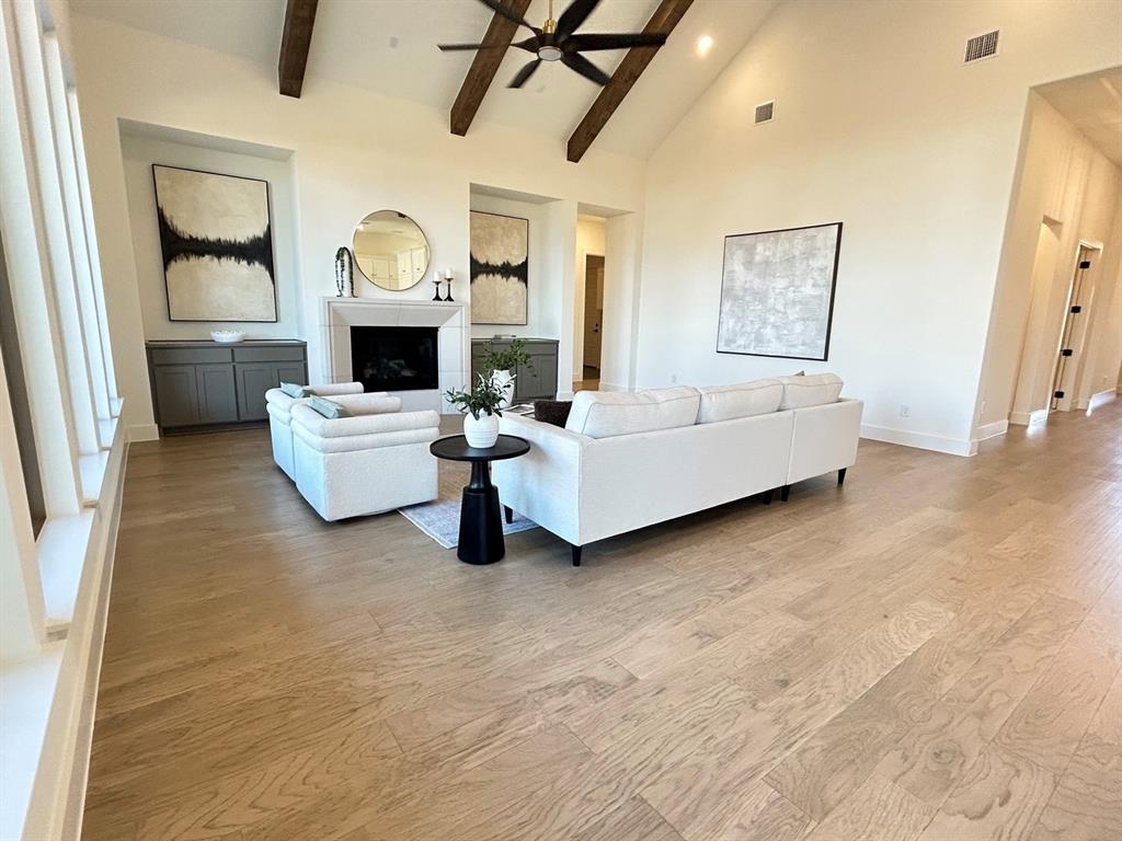 4416 Meander Way Prosper, TX 75078 - Photo 4 of 40 a living room with furniture and a fireplace