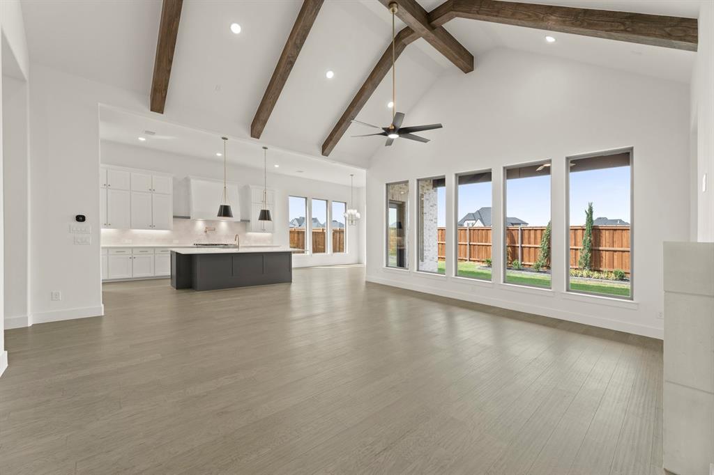4416 Meander Way Prosper, TX 75078 - Photo 8 of 40 a view of an empty room with a window and wooden floor