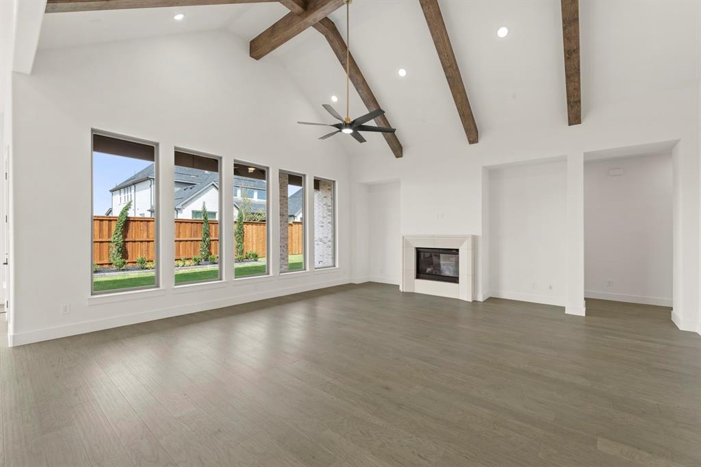 4416 Meander Way Prosper, TX 75078 - Photo 10 of 40 an empty room with wooden floor and windows