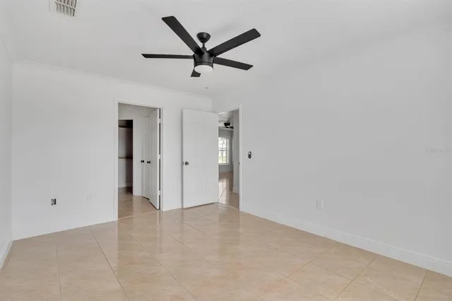 a view of a livingroom with a ceiling fan and window