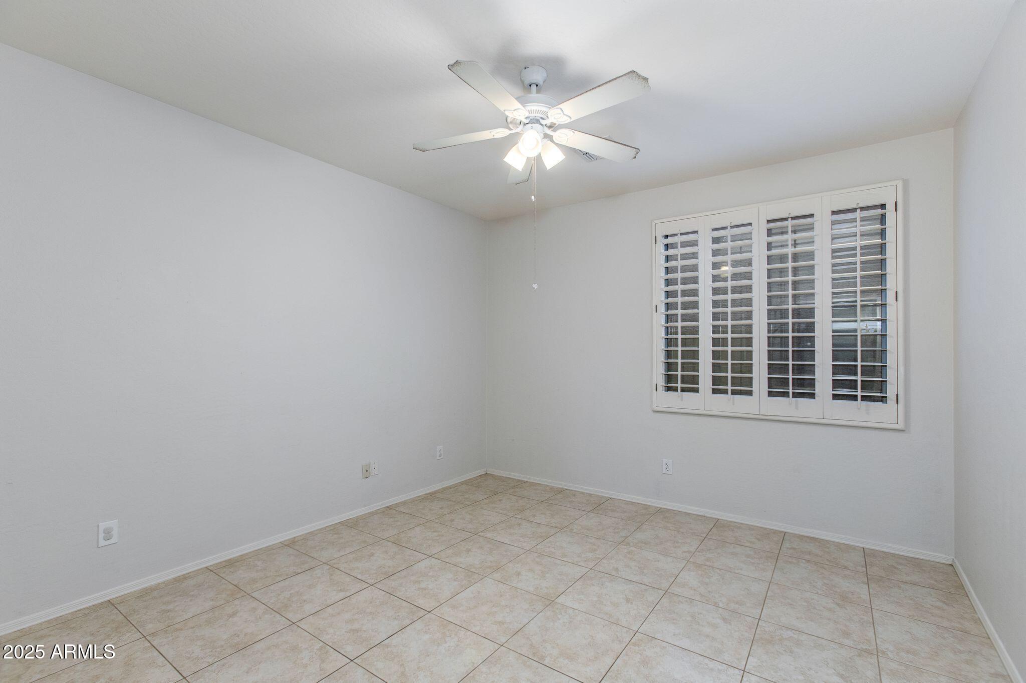 40332 North High Noon Way Phoenix, AZ 85086 - Photo 15 of 25 an empty room with chandelier fan and windows