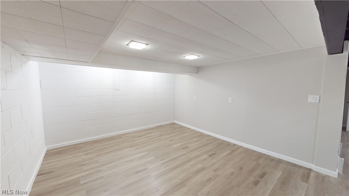 1224 Cordova Road Mayfield Heights, OH 44124 - Photo 23 of 29 Basement featuring light hardwood / wood-style flooring and a paneled ceiling