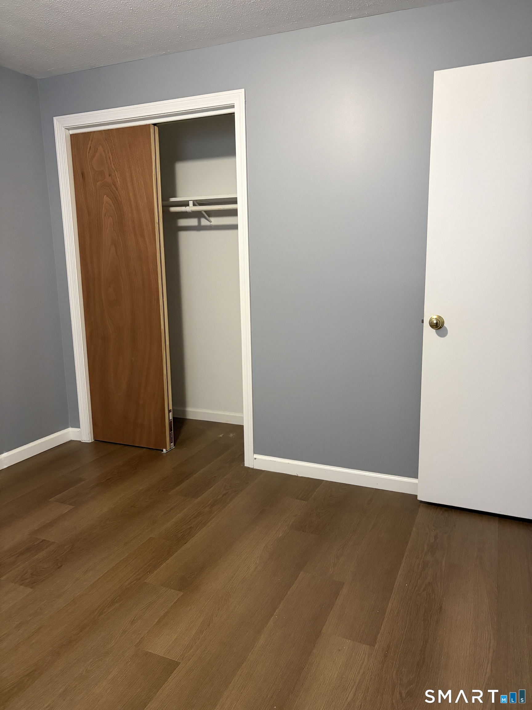 270 South Windham Road, Unit 63 Windham, CT 06226 - Photo 11 of 19 an empty room with wooden floor and closet