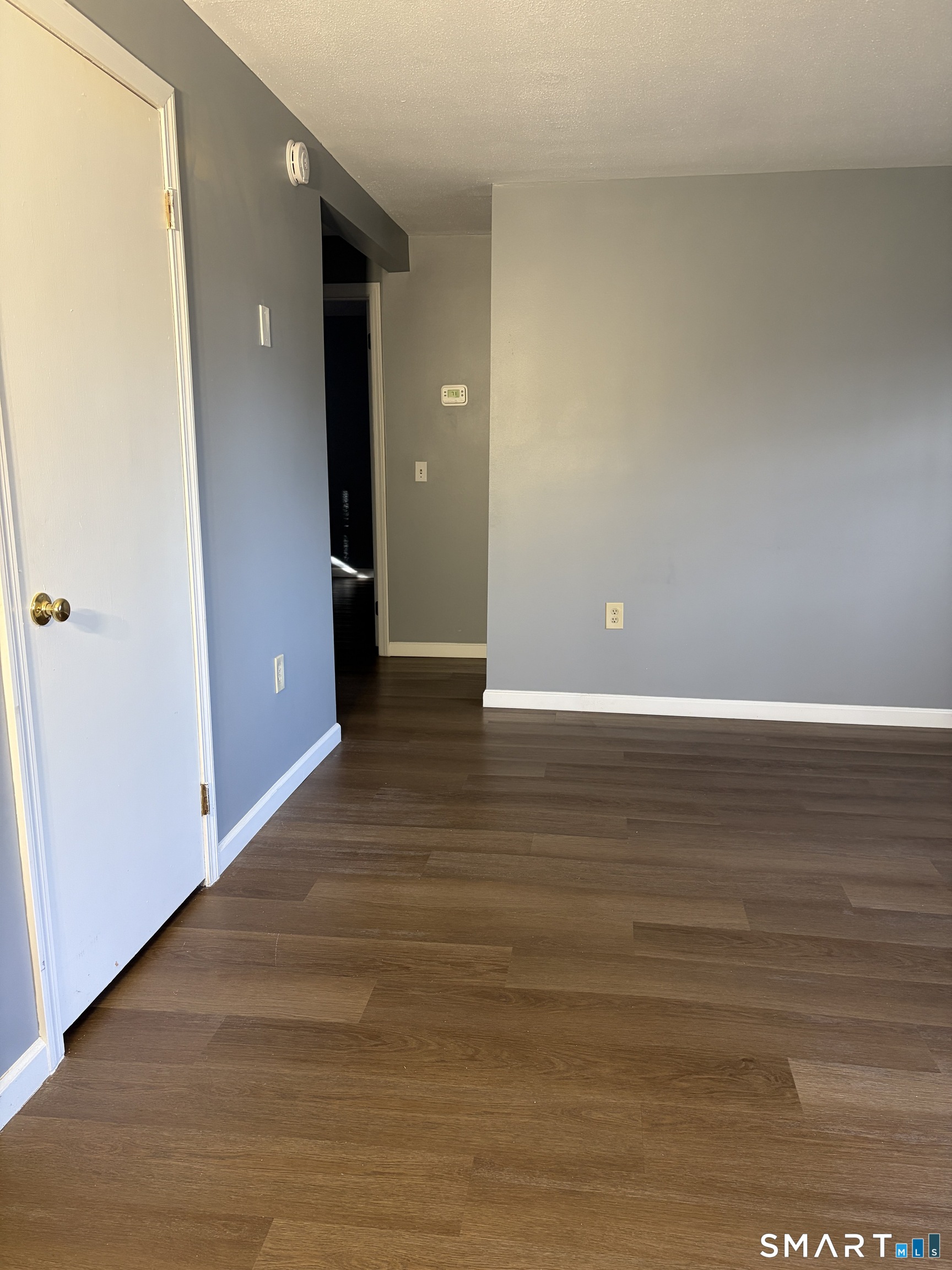 270 South Windham Road, Unit 63 Willimantic, CT 06226 - Photo 5 of 18 a view of an empty room with wooden floor